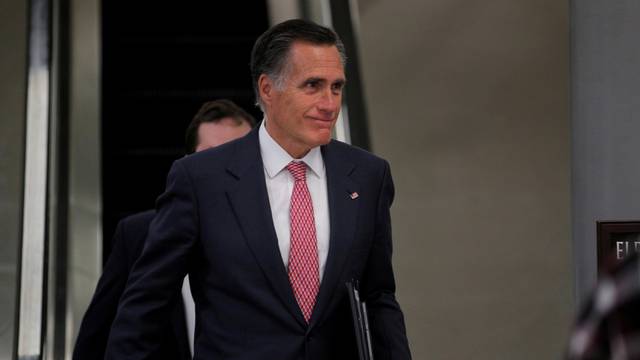 FILE PHOTO: Senator Mitt Romney exits at the end of the day as the Trump impeachment trial continues in Washington