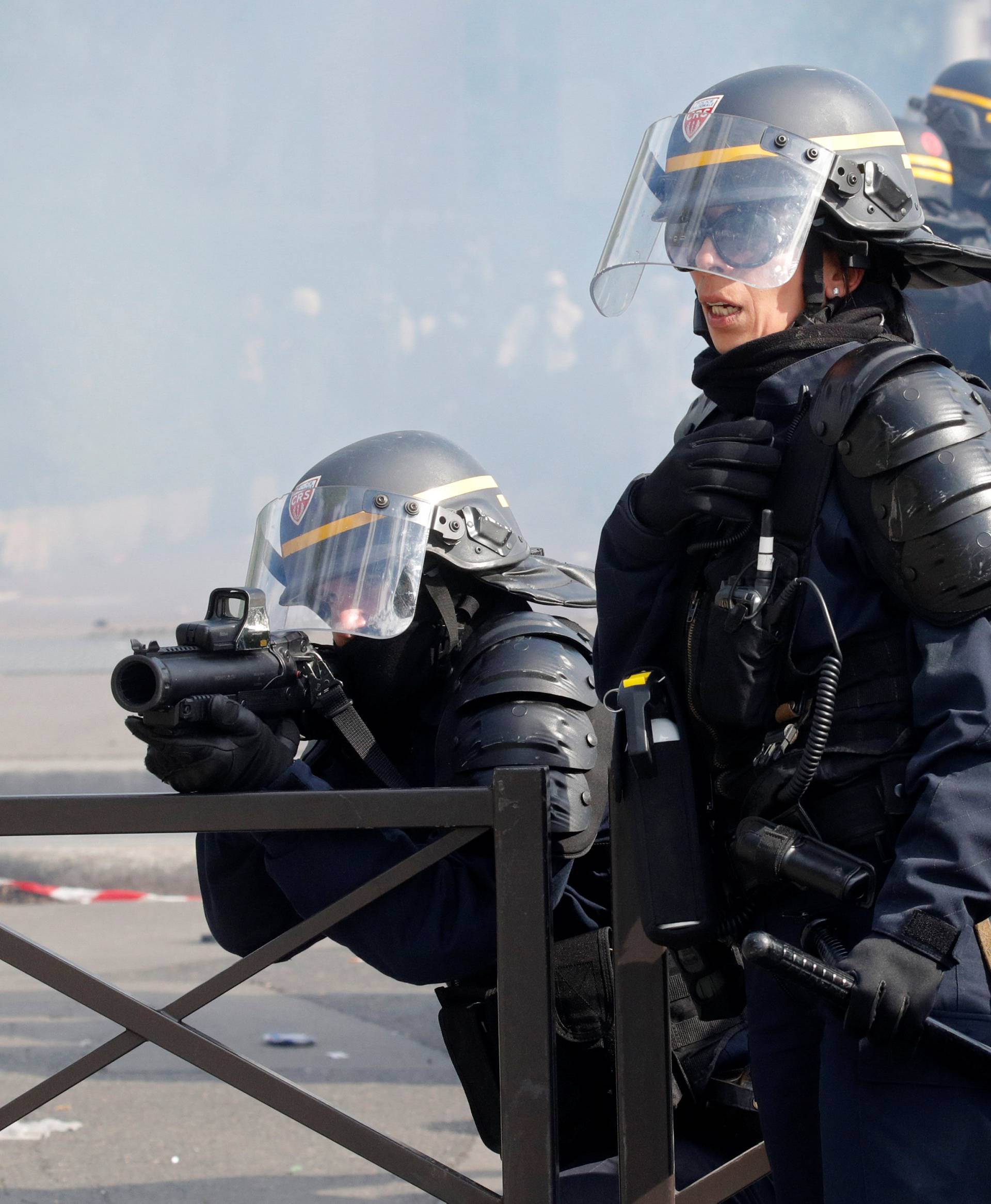 French CRS riot police secure a position during clashes with protesters at the May Day labour union rally in Paris