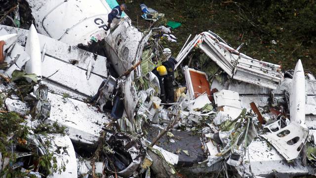 Rescue crew work in the wreckage from a plane that crashed into Colombian jungle with Brazilian soccer team Chapecoense near Medellin