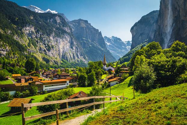 Picturesque waterfall and famous village in the Lauterbrunnen valley, Switzerland