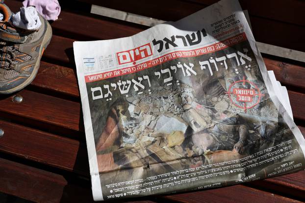 A newspaper with a screengrab from the video released by the Israeli army showing the body of the late Hamas leader Sinwar lies on a bench in Tel Aviv