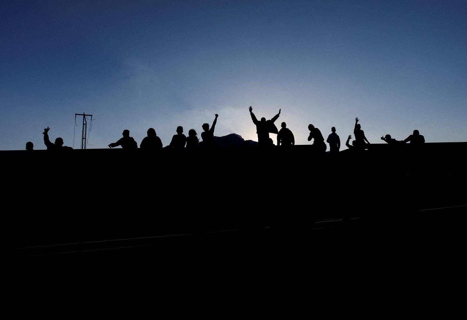 Asylum seekers heading to the U.S. travel on a train, in El Carmen