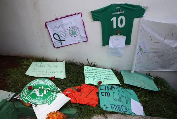 Flowers and messages are seen next to a Chapecoense soccer team flag in tribute to their players in front of the Arena Conda stadium in Chapeco