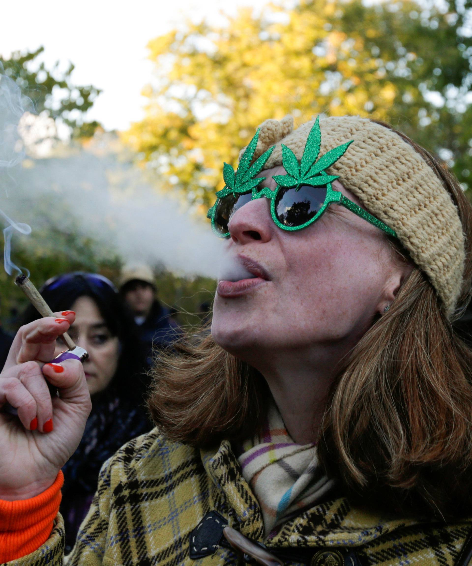 A woman smokes a joint on the day Canada legalizes recreational marijuana at Trinity Bellwoods Park in Toronto