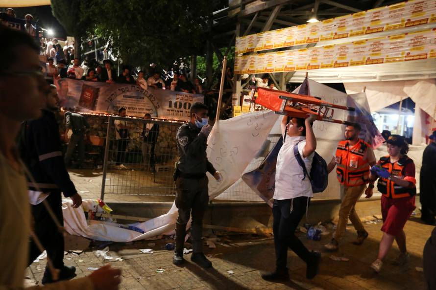 A man carries a stretcher at the Lag B'Omer event in Mount Meron, northern Israel, where fatalities were reported among the thousands of ultra-Orthodox Jews gathered