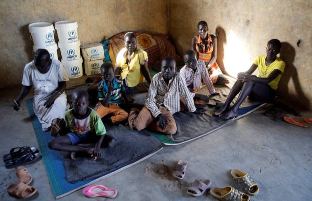 A South Sudanese refugee family from Jonglei State sits inside a makeshift structure at the reception centre of the Kakuma refugee camp in Turkana county, northwest of Nairobi