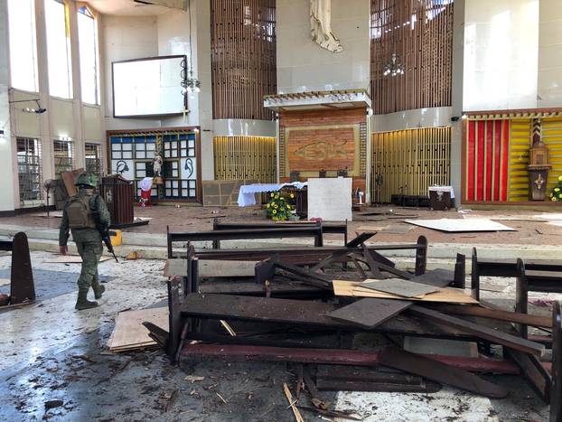 Philippine Army member walks inside church after bombing attack in Jolo