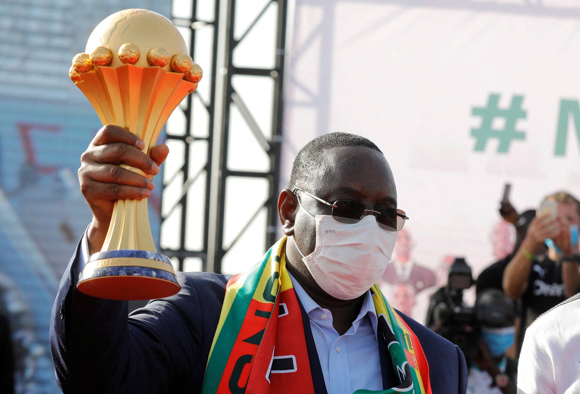 Senegal's President Macky Sall holds the trophy as he welcomes the Senegal National Soccer Team after their Africa Cup win, in Dakar