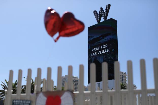 Balloons fly near a "Pray for Las Vegas" message along Las Vegas Boulevard after a mass shooing on the Las Vegas Strip in Las Vegas