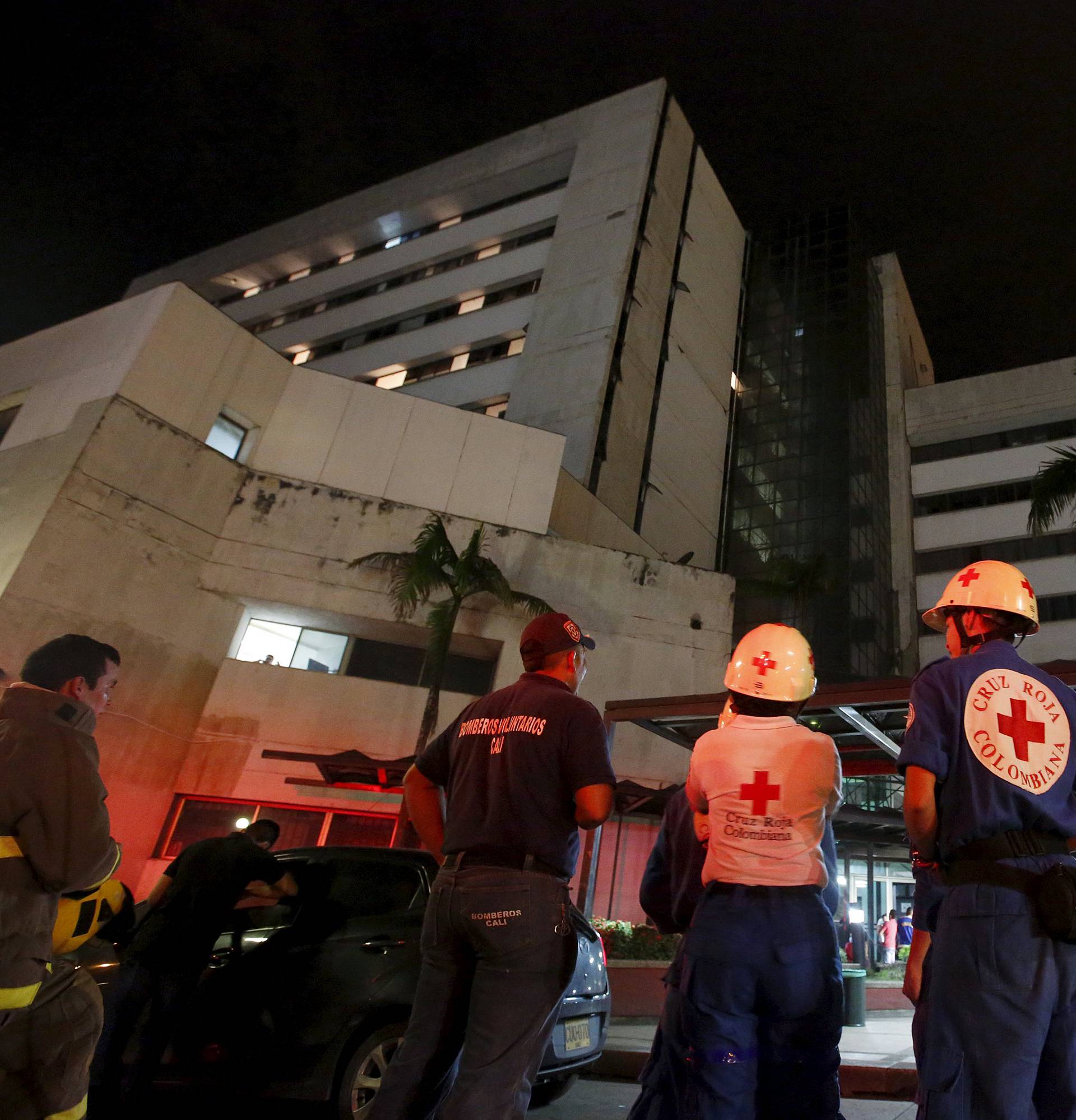 Rescue team members wait outside a clinic that was evacuated after tremors were felt resulting from an earthquake in Ecuador, in Cali, Colombia