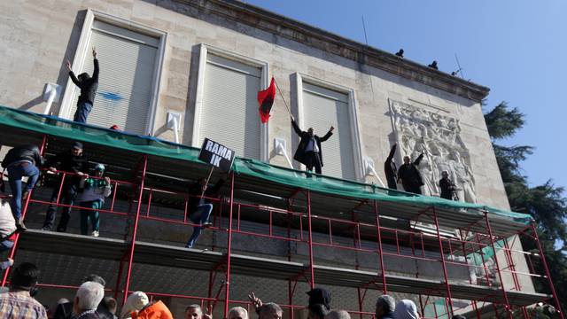 Supporters of the opposition party try to break into a government building that houses the office of Prime Minister Edi Rama during an anti-government protest in Tirana