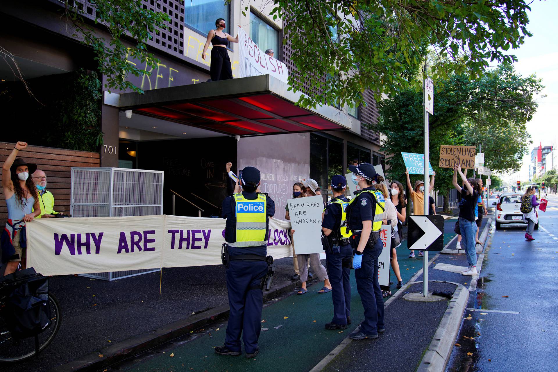 Pro-refugee protestors demonstrate at the Park Hotel, where Serbian tennis player Novak Djokovic is believed to be held, in Melbourne