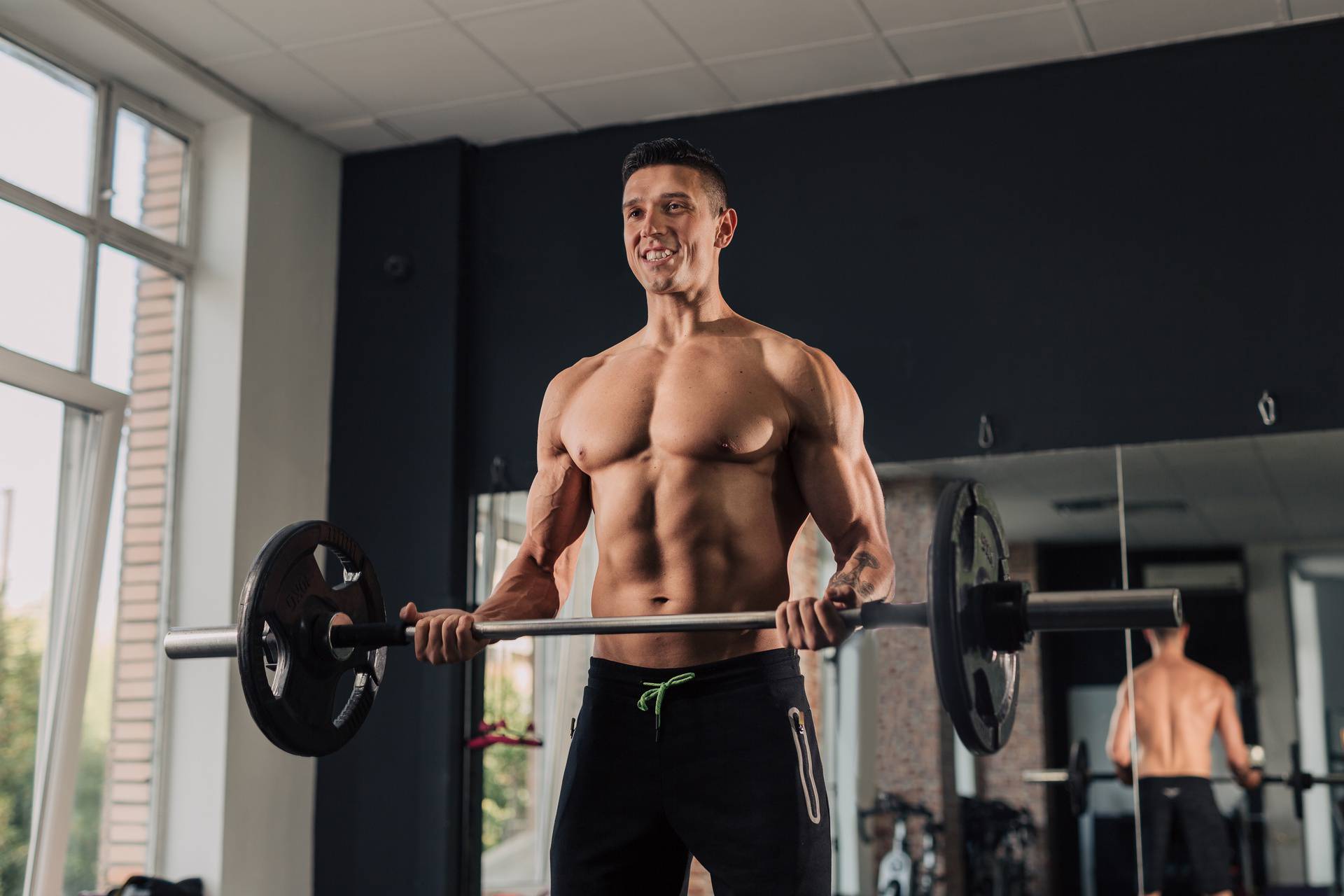 Young muscular man in the gym doing exercise