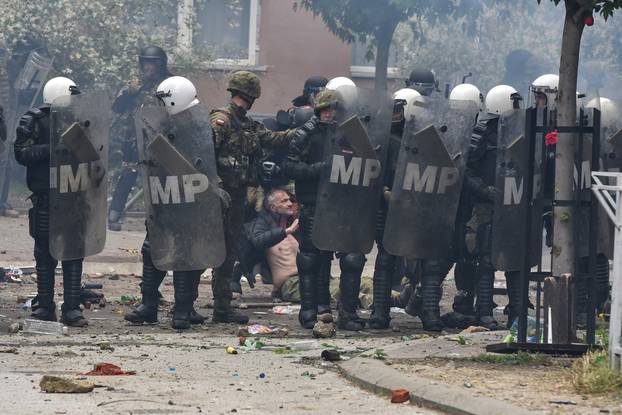 NATO Kosovo Force (KFOR) soldiers clash with local Kosovo Serb protesters in the town of Zvecan