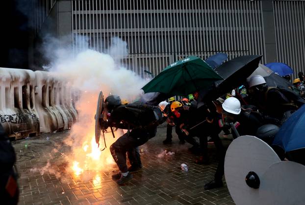 Demonstrators take cover during a protest in Hong Kong