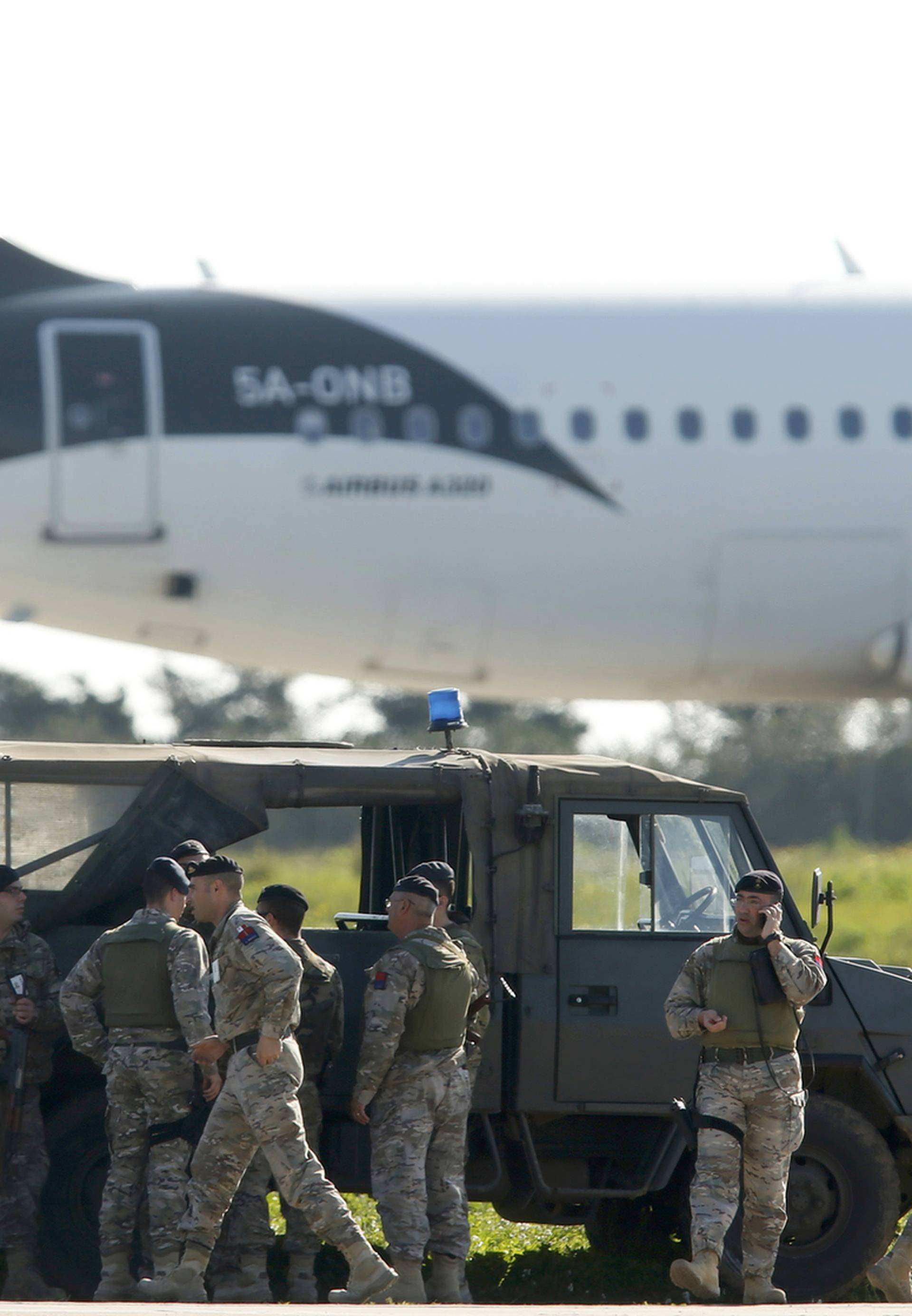 Maltese troops survey a hijacked Libyan Afriqiyah Airways Airbus A320 on the runway at Malta Airport