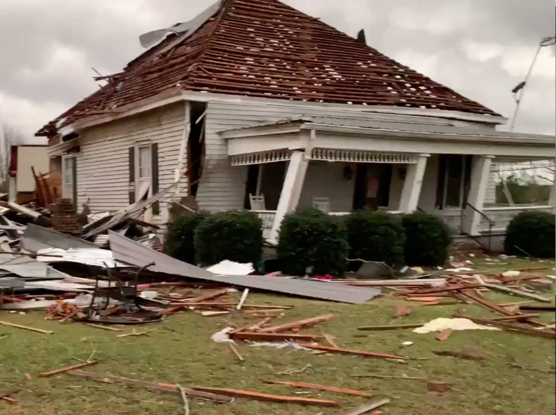 Debris and a damaged house seen following a tornado in Beauregard, Alabama, U.S. in this March 3, 2019 still image obtained from social media video