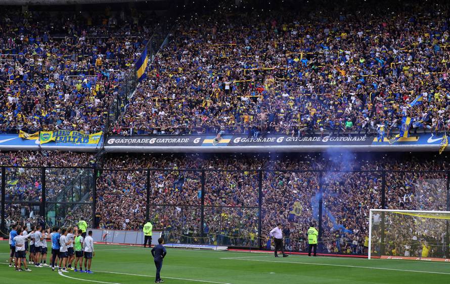 Boca Juniors' players acknowledge supporters during a training session ahead of their second leg Copa Libertadores final match against River Plate in Buenos Aires