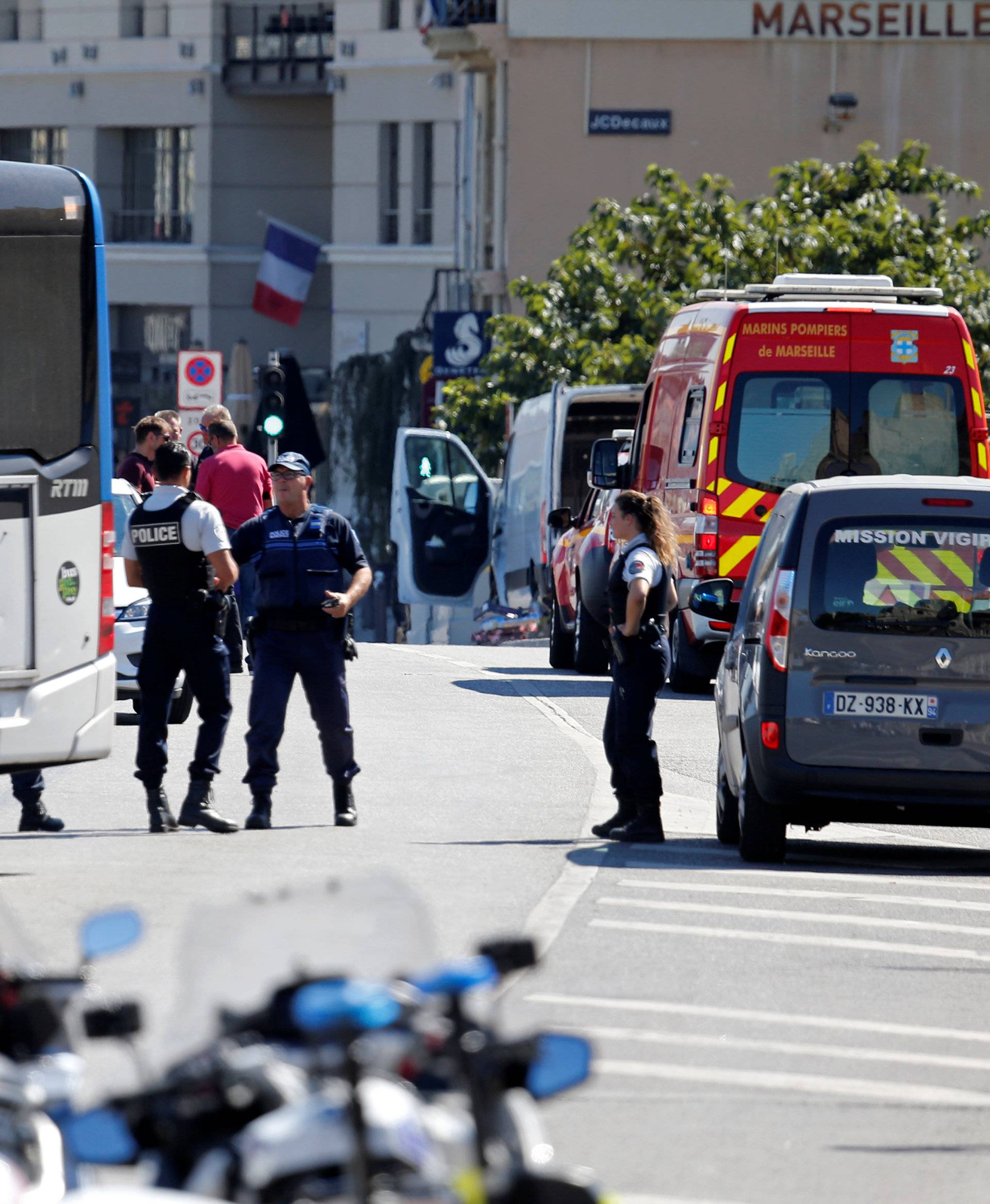 French police secure the area in the French port city of Marseille where one person was killed and another injured after a car crashed into two bus shelters