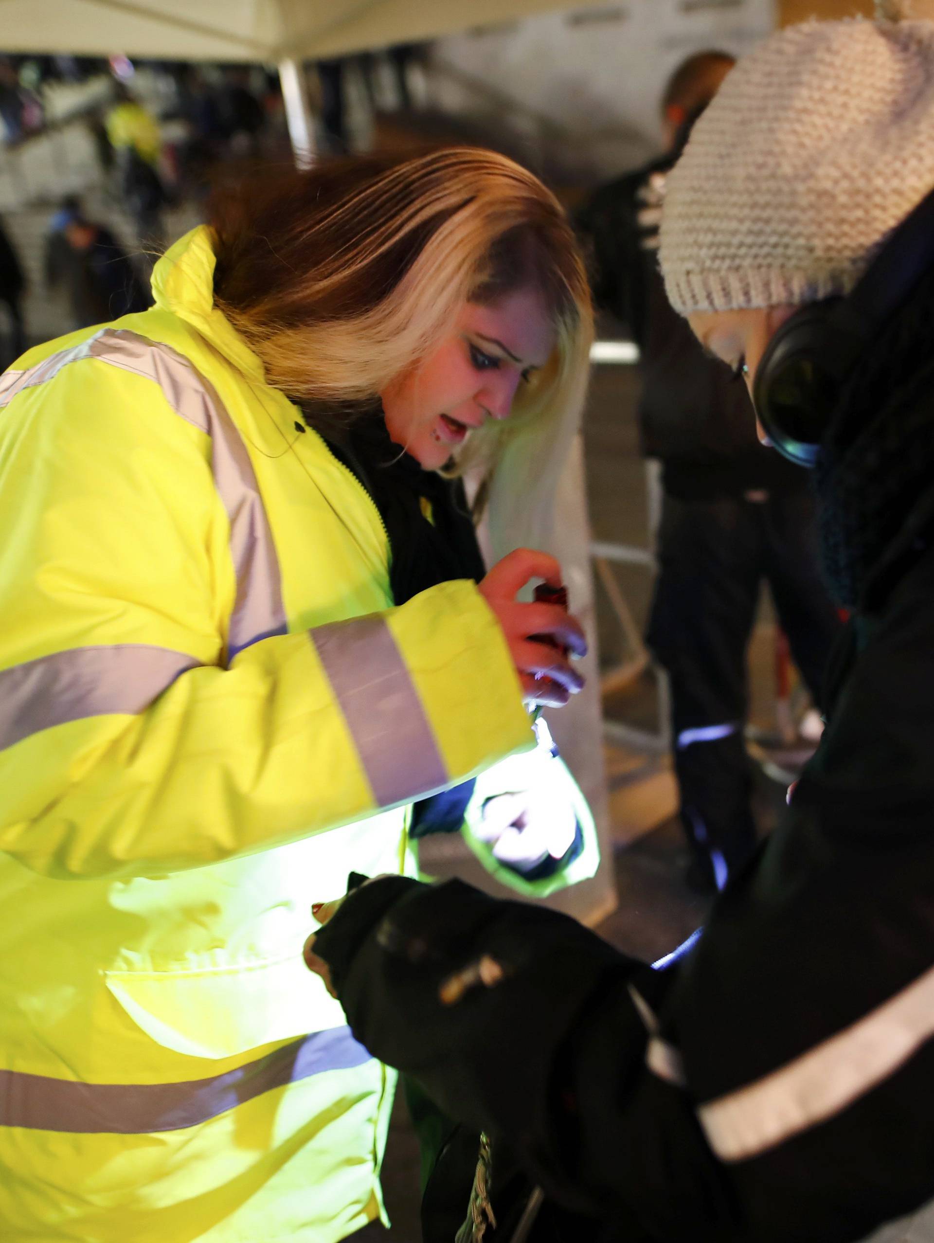 A security officer performs security checks before the New Year celebrations for 2017 in Cologne