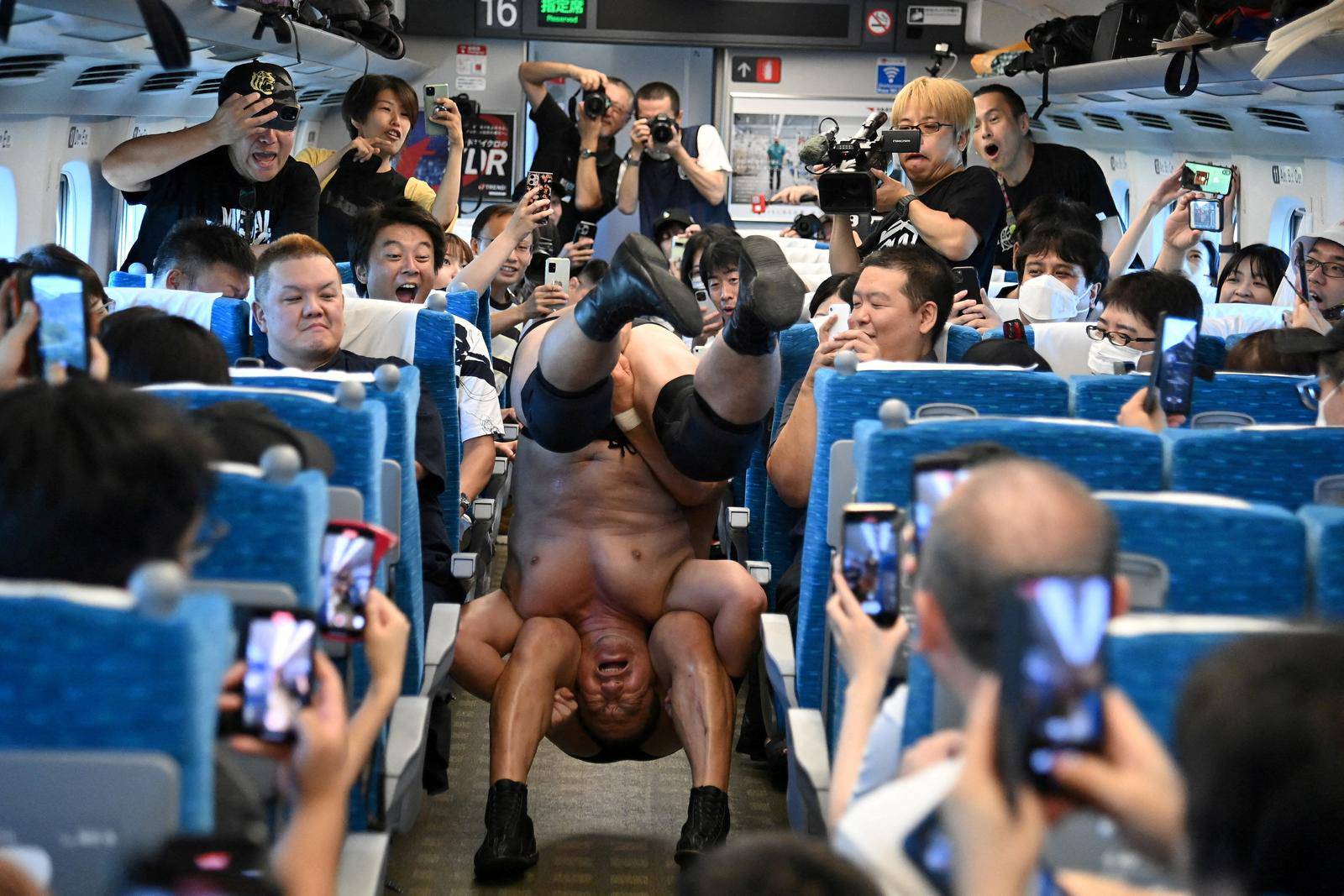 Handout photo shows DDT Pro-Wrestling wrestlers fight inside Tokaido Shinkansen bullet train in Japan