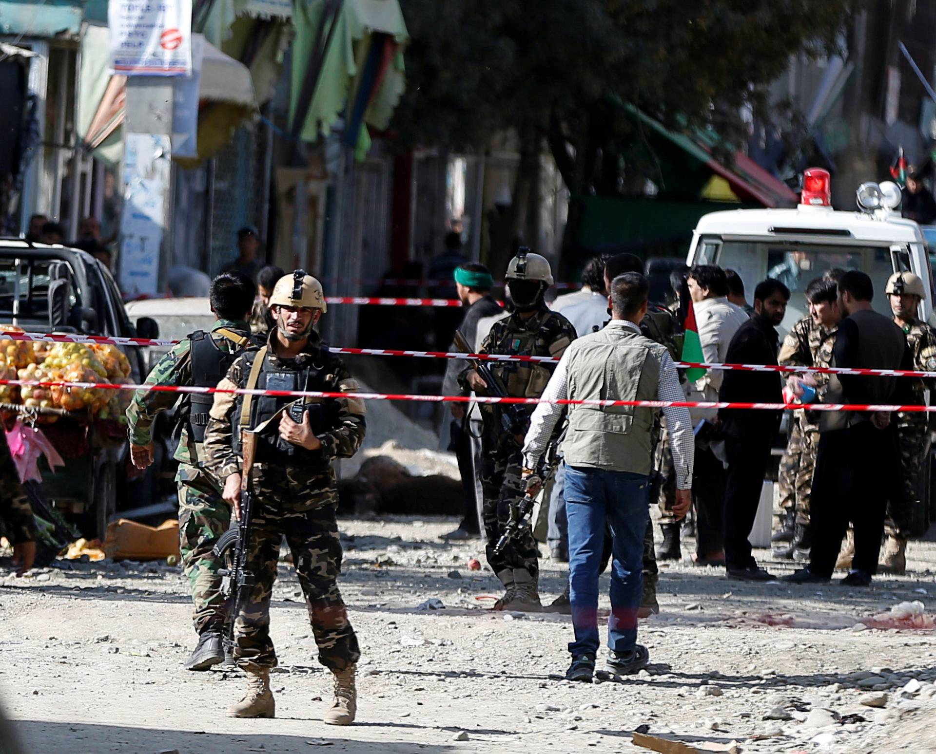 Afghan security forces inspect the site of a suicide attack near a large Shi'ite mosque, Kabul, Afghanistan