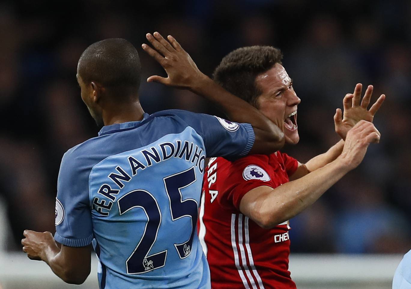 Manchester City's Fernandinho clashes with Manchester United's Ander Herrera