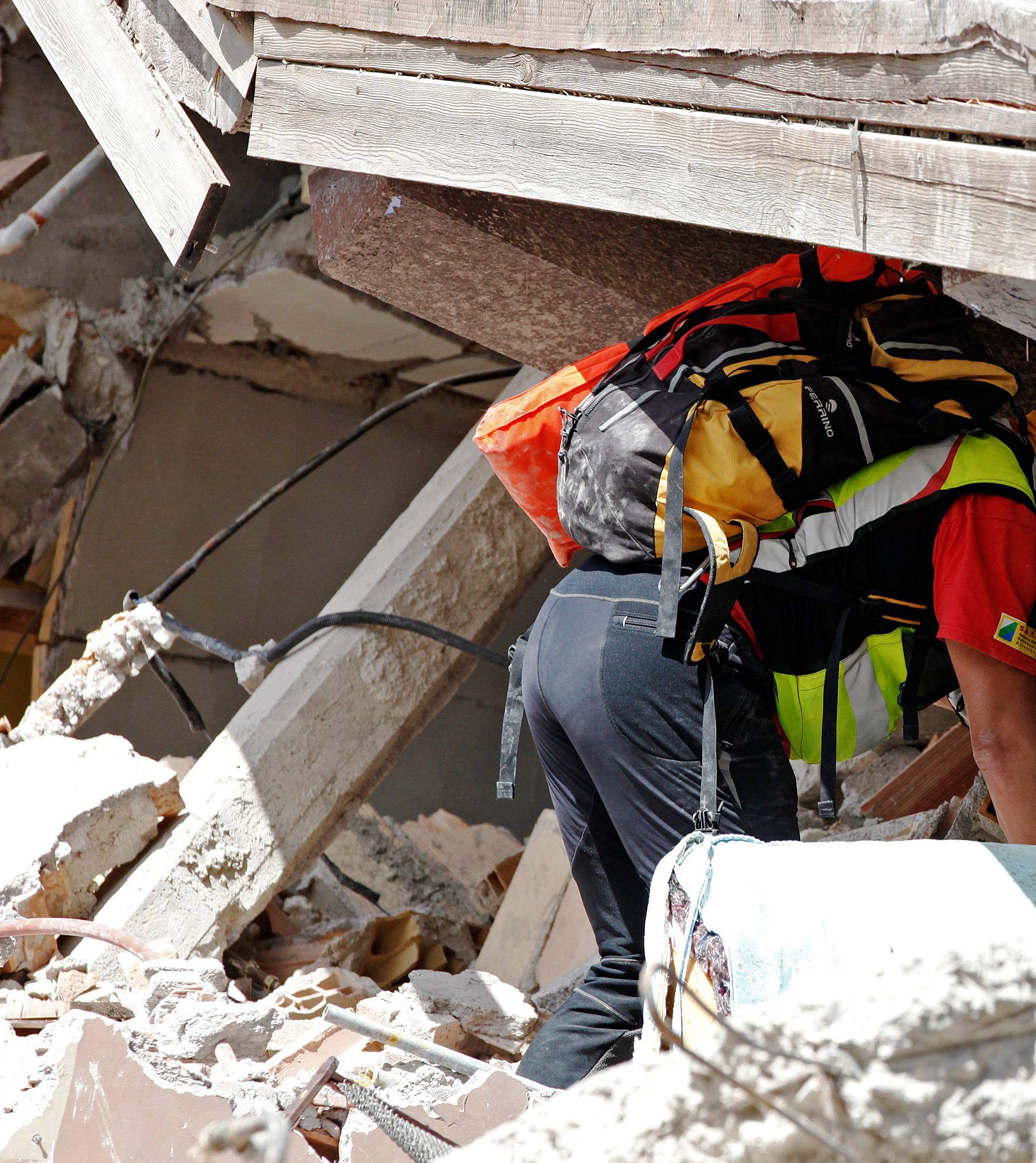A rescuer works following an earthquake in Amatrice