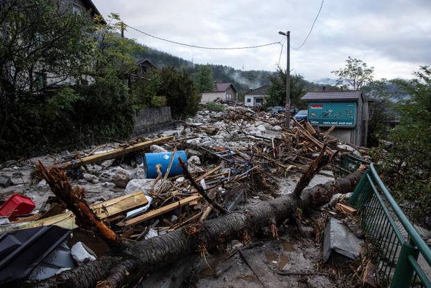 Rubble lies around a flooded residential area in Donja Jablanica