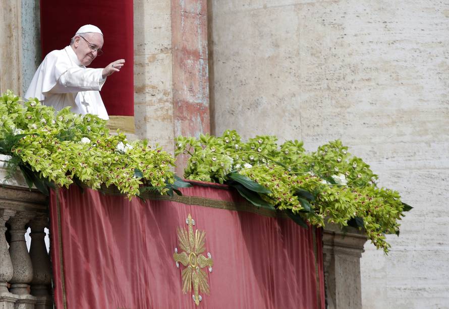 Pope Francis waves after delivering his Easter message in the Urbi et Orbi (to the city and the world) address from the balcony overlooking St. Peter's Square at the Vatican