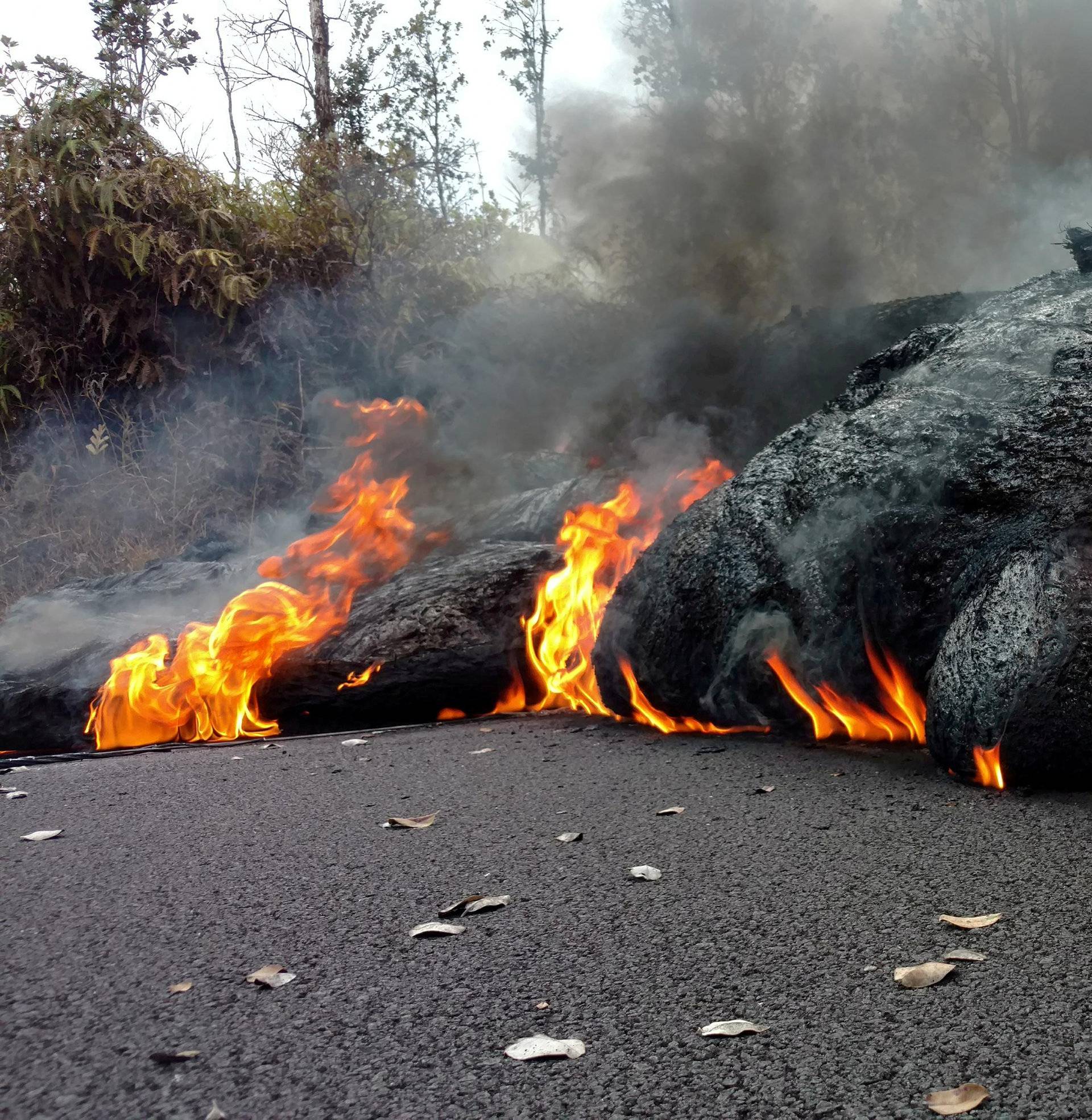 A lava flow is seen on a road in Pahoa