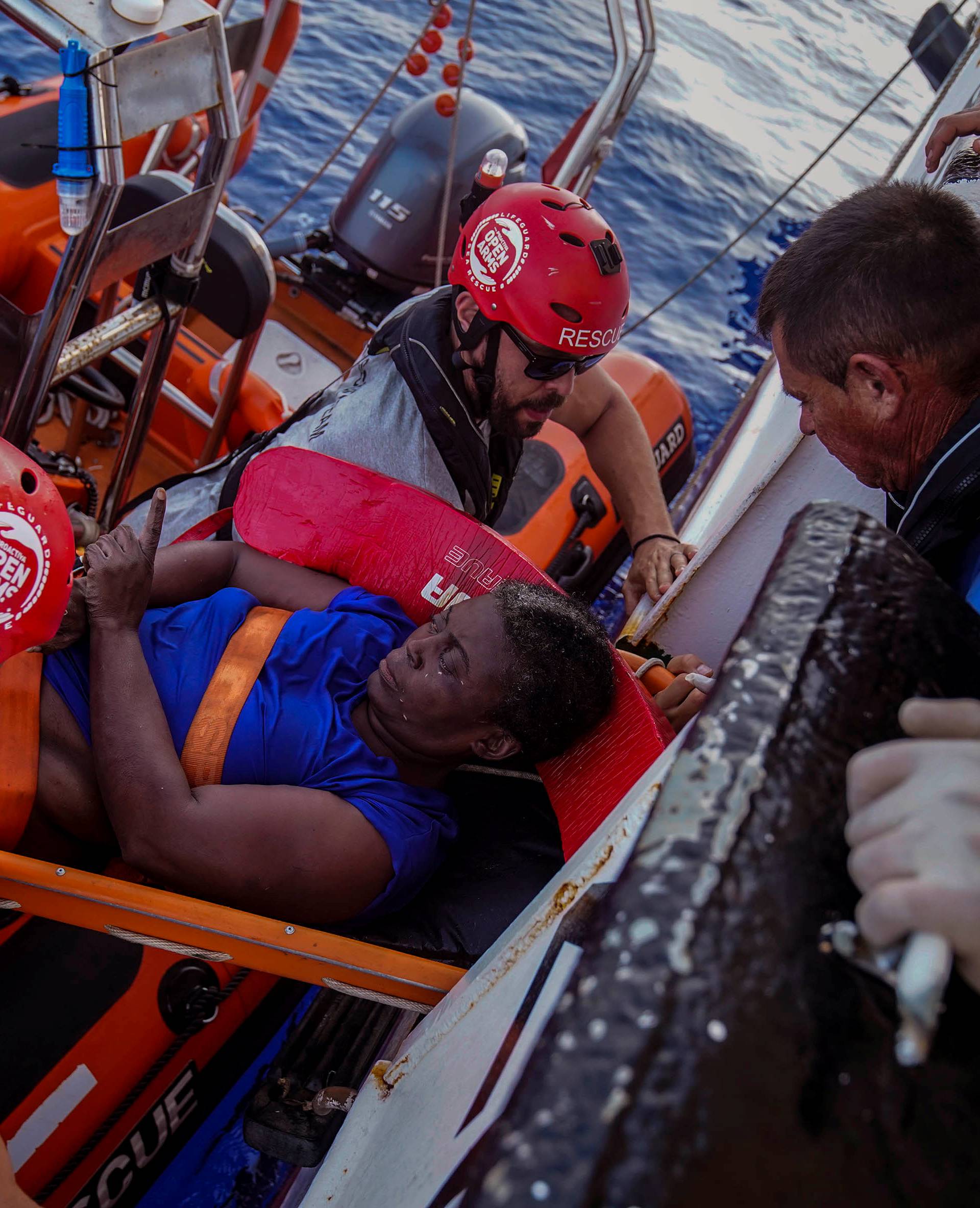 NBA Memphis player Marc Gasol and members of NGO Proactiva Open Arms rescue boat carry an African migrant in central Mediterranean Sea