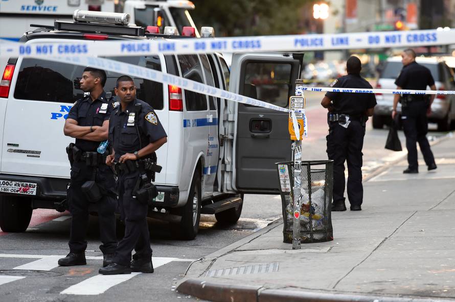 NYPD officers stand near the site of an explosion in New York