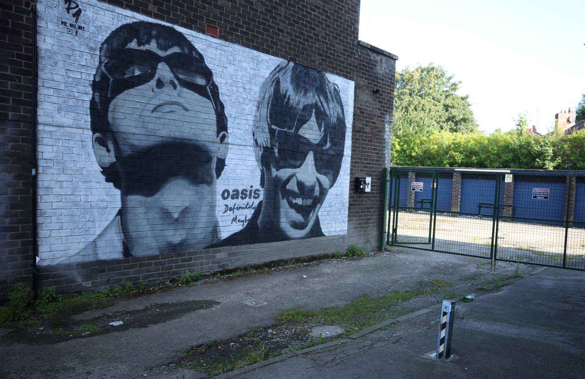 A view of a mural of Oasis band members Liam and Noel Gallagher by artist Pic.One.Art on the side of Sifters record shop in the Burnage area of Manchester