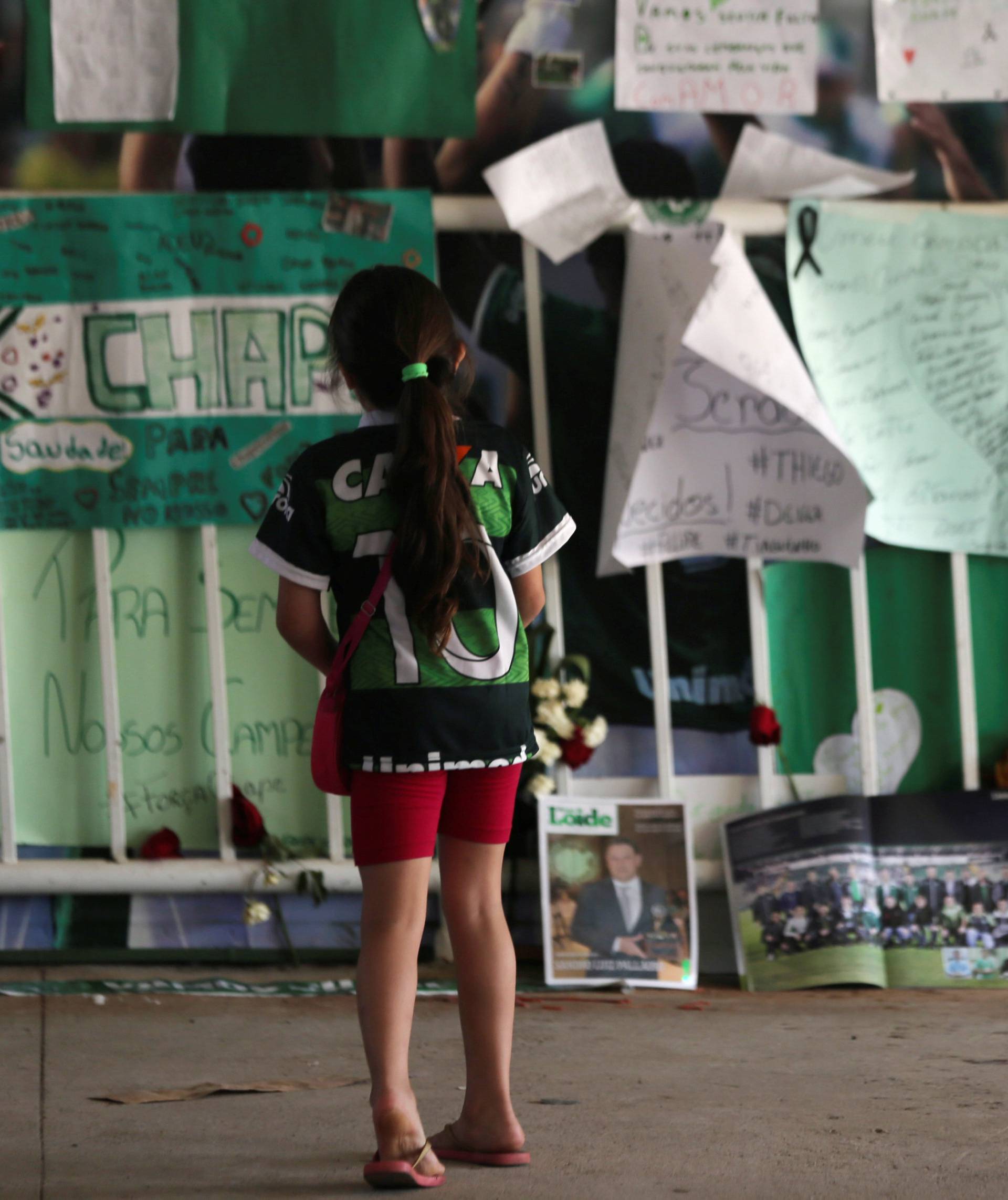 A young fan of Chapecoense soccer team pays tribute to Chapecoense's players at the Arena Conda stadium in Chapeco