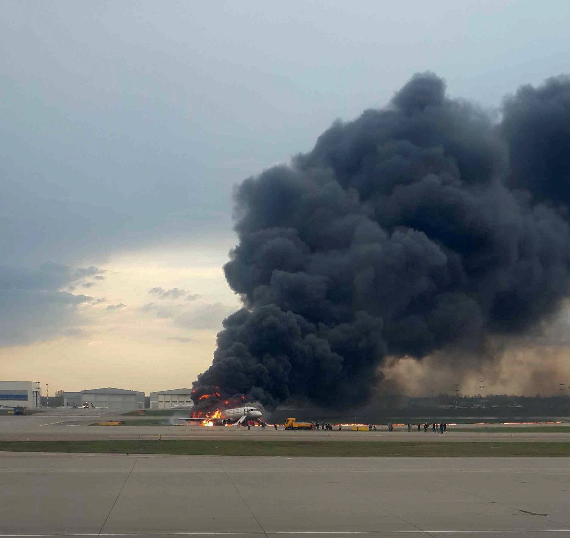 A passenger plane is seen on fire after an emergency landing at the Sheremetyevo Airport outside Moscow