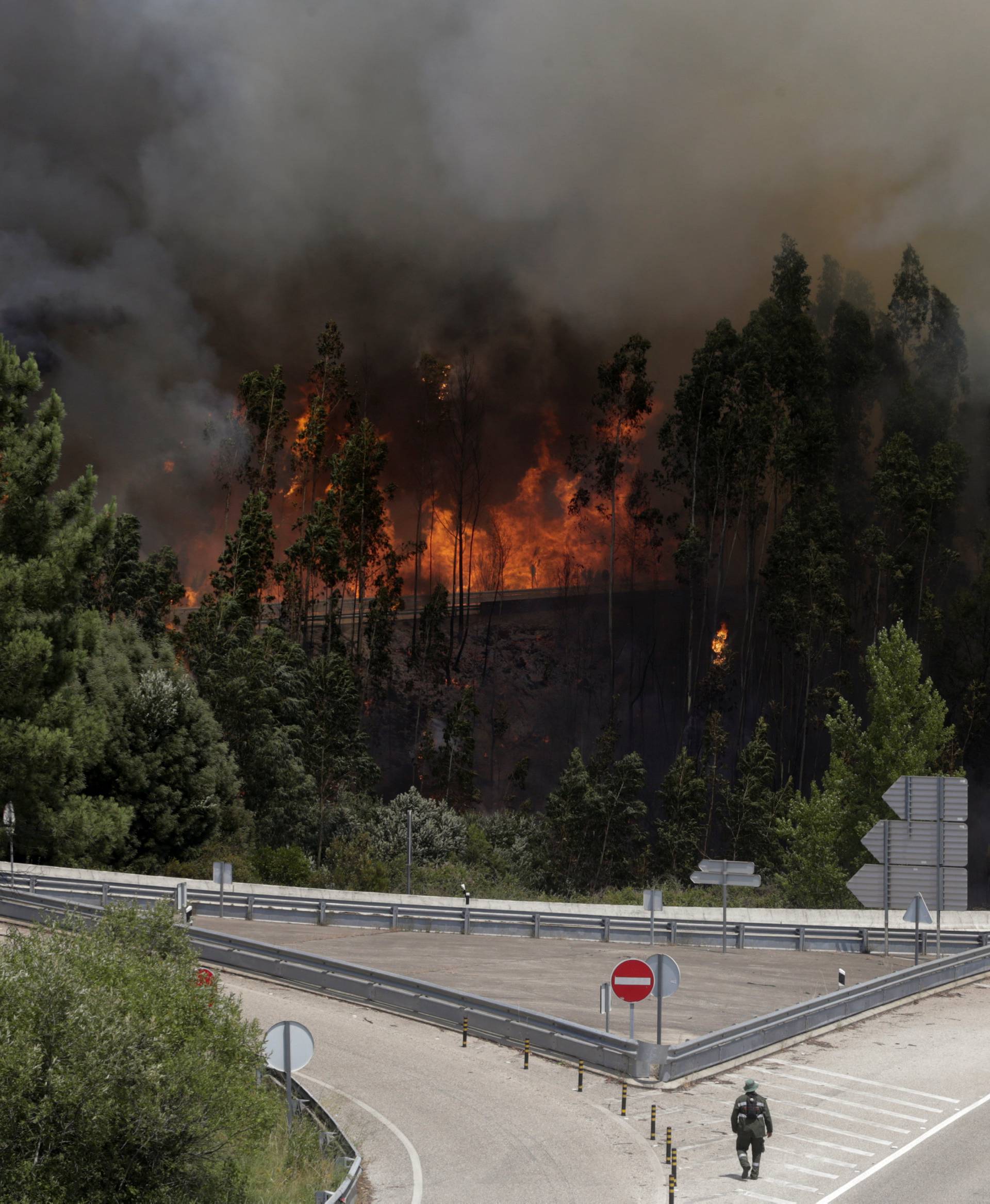 Fire and smoke is seen on the IC8 motorway during a forest fire near Pedrogao Grande