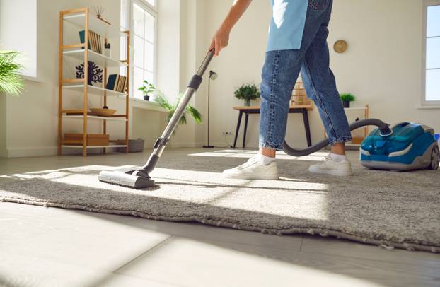 Cropped,Photo,Of,Woman,Cleaning,With,Vacuum,Cleaner,Carpet,In