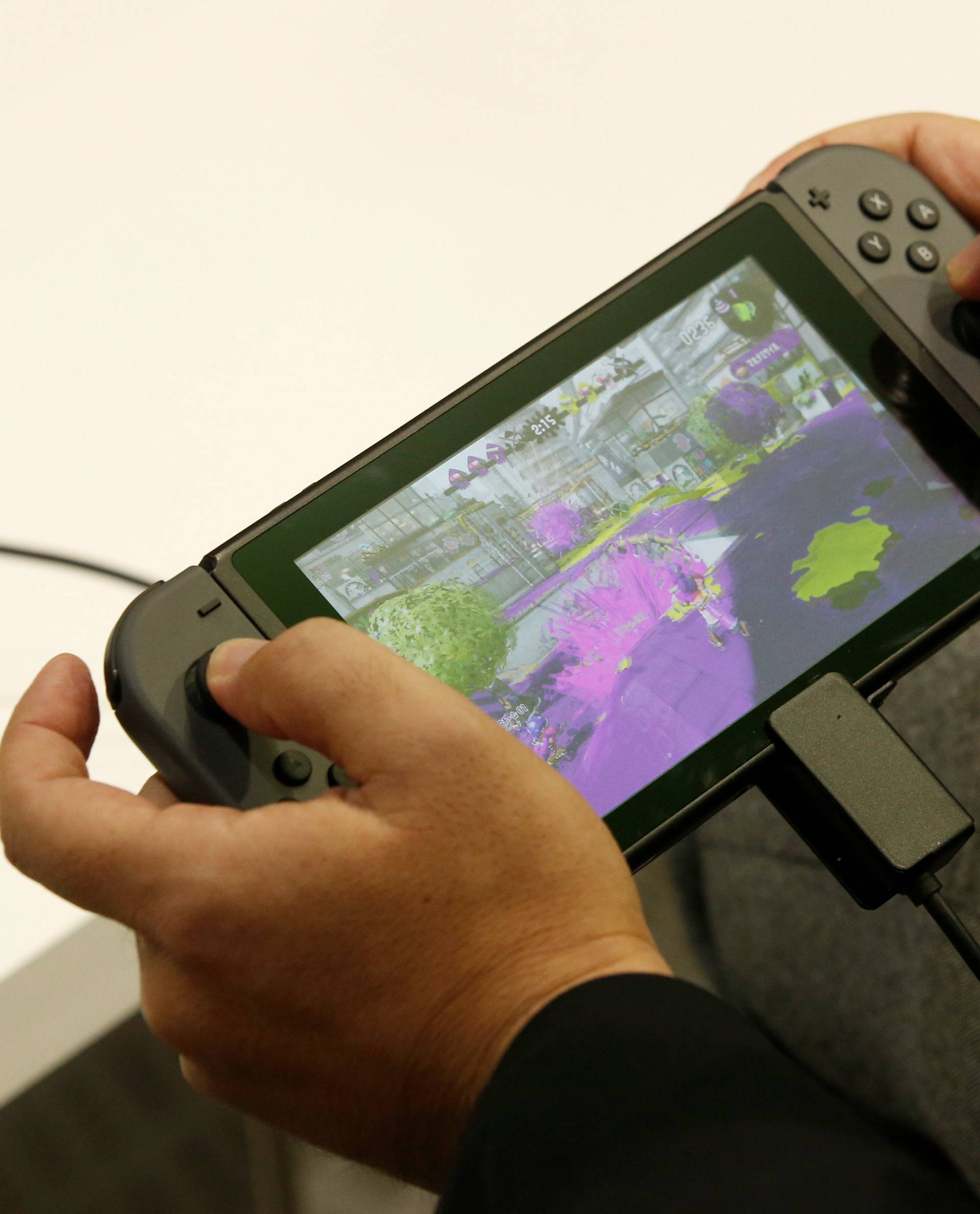 A man plays Nintendo's new game console Switch at its experience venue in Tokyo