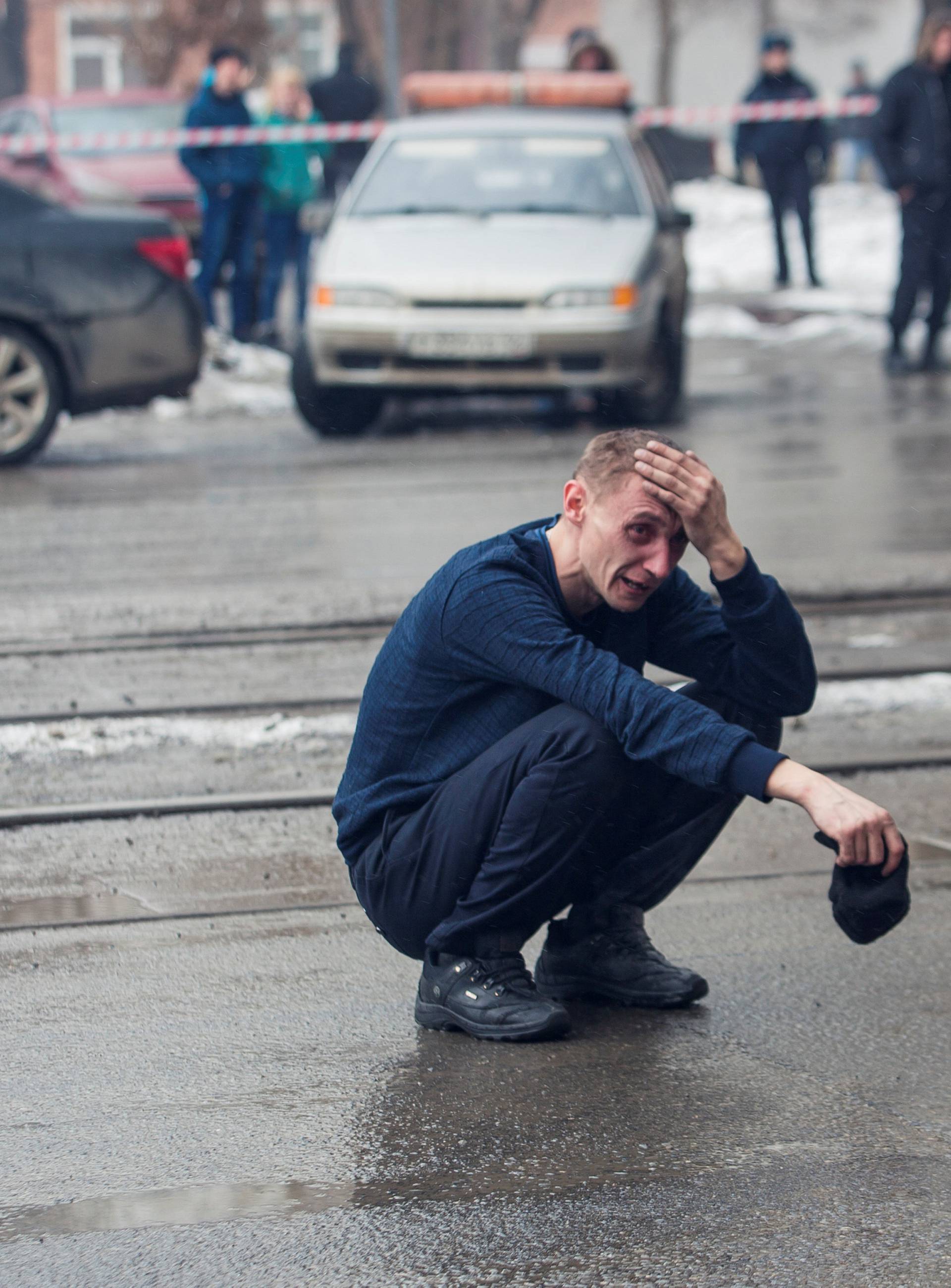 A man reacts at the scene of a fire in a shopping mall in Kemerovo