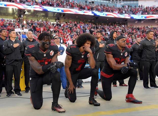 FILE PHOTO: San Francisco 49ers outside linebacker Harold, quarterback Kaepernick and free safety Reid kneel in protest in Santa Clara