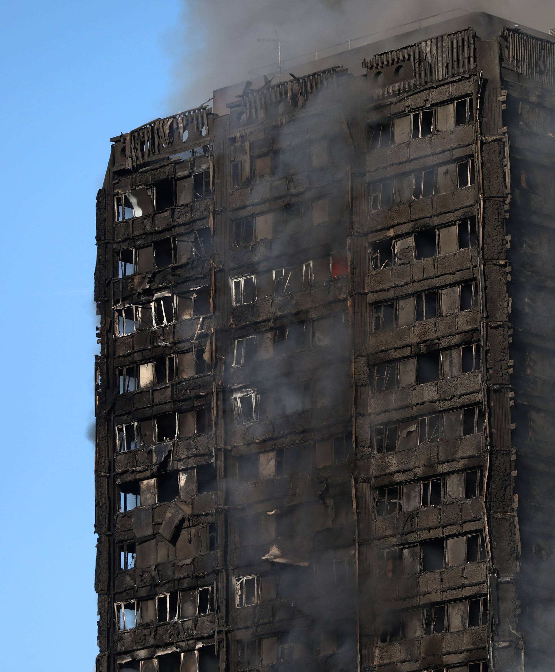 Smoke billows as firefighters tackle a serious fire in a tower block at Latimer Road in West London