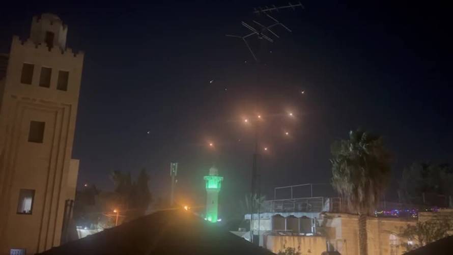 Projectiles from Iranian missile attack flash in the sky over Jerusalem
