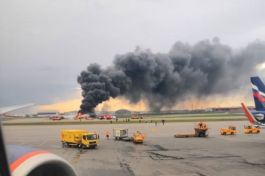 A passenger plane is seen on fire after an emergency landing at the Sheremetyevo Airport outside Moscow