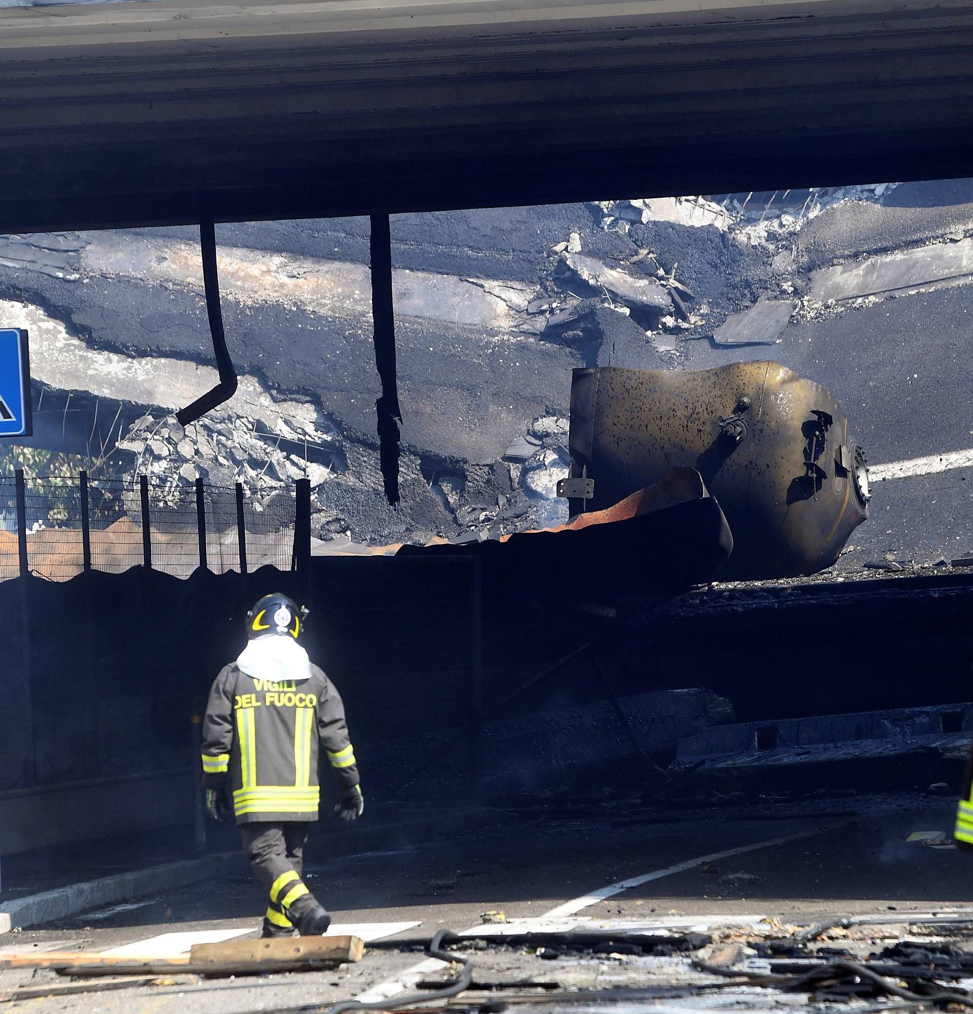 Firefighters work near the motorway after an accident caused a large explosion and fire at Borgo Panigale, on the outskirts of Bologna