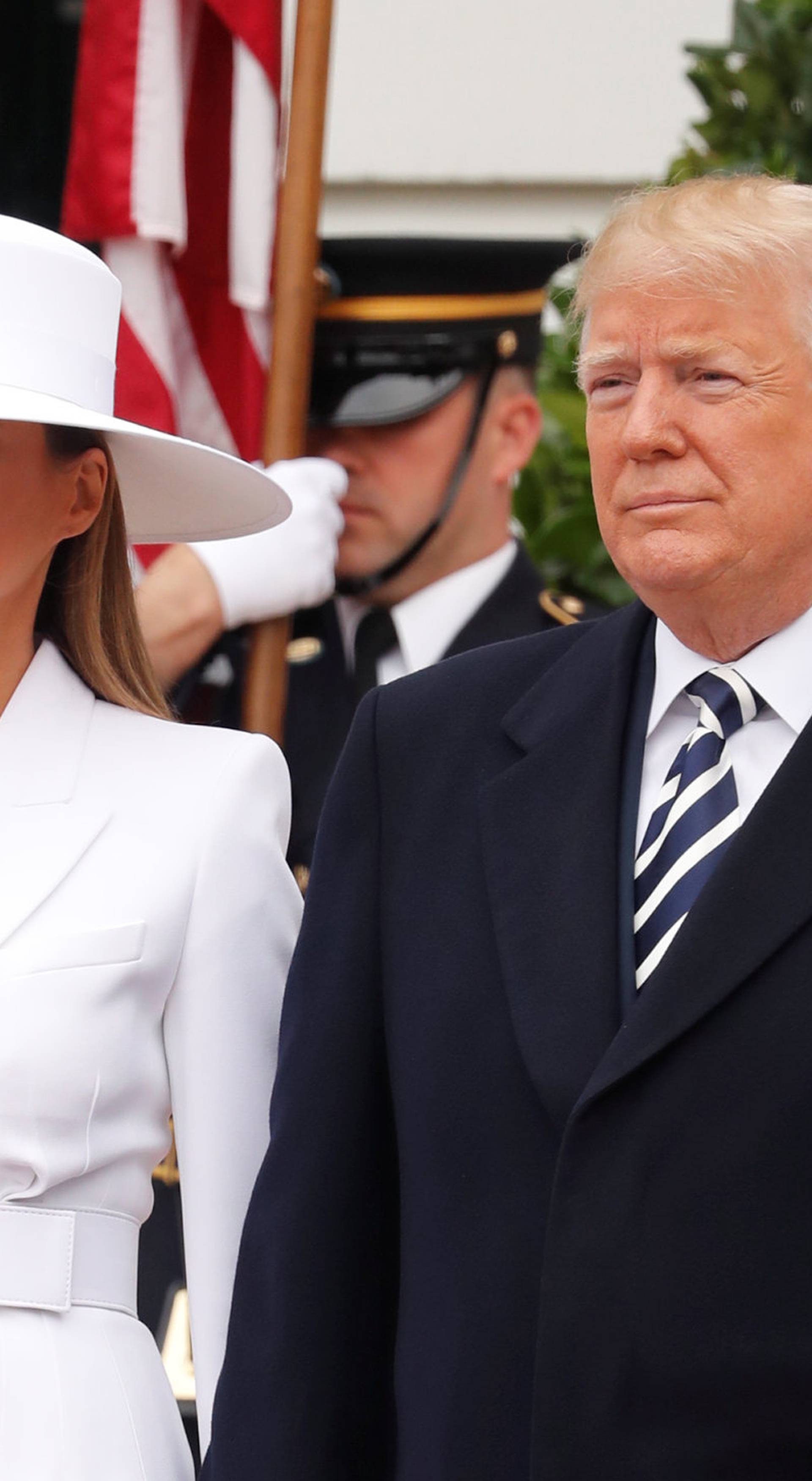 U.S. President Trump and first lady Melania wait to welcome French President Macron and his wife Brigitte during arrival ceremony at the White House in Washington