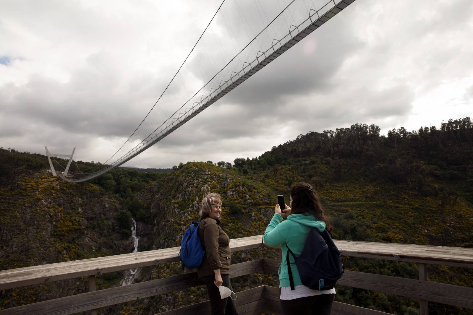 People walk on the world's longest pedestrian suspension bridge '516 Arouca', in Arouca