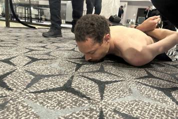 Law enforcement personnel detain Cole Tomas Allen, a suspect in the shooting incident at the White House Correspondents' Association dinner, in Washington