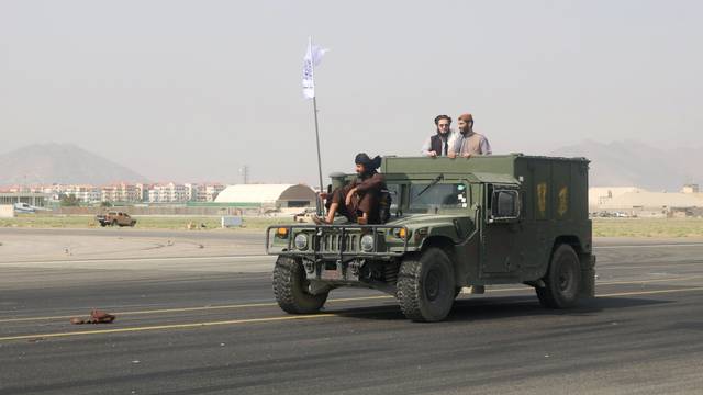 Taliban forces patrol at a runway a day after the U.S. troops withdrawal from Hamid Karzai international airport n Kabul