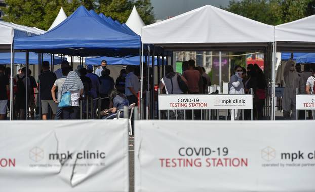 People queue in front of the coronavirus disease (COVID-19) testing facility in Almaty